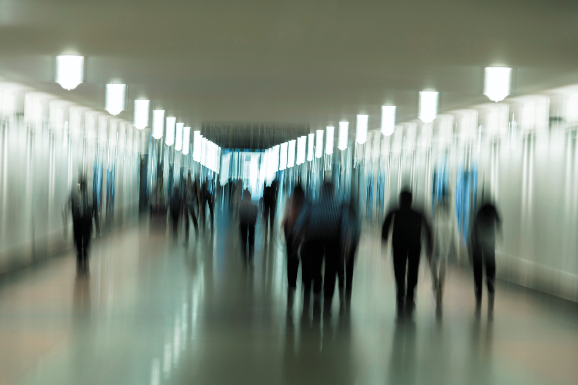 People are walking through the subway in a blur